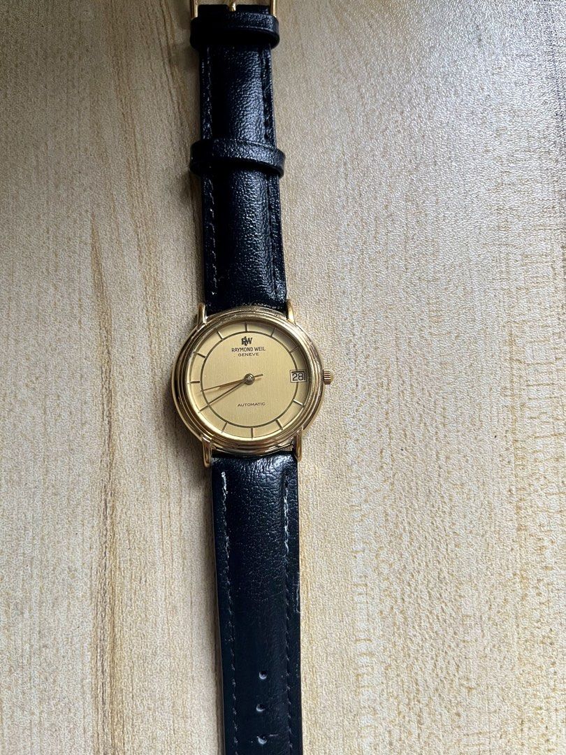Raymond Weil Geneva Automatic Gold Watch (Category: Luxury Watches) located in Makati City. Submitted by lovefashionstuff (Listing ID 1468323716, Image 3). Description: Brand/Model: Raymond Weil Geneve Automatic Watch (Ref. 2811) Dial: Gold dial with convenient date window at the 3 o'clock position Case: 18k gold electroplated case with water-resistant caseback - Strap: Black genuine leather strap paired with a matching gold-tone buckle - Conditi