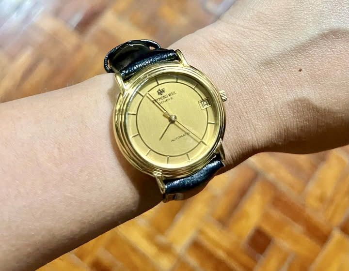 Raymond Weil Geneva Automatic Gold Watch (Category: Luxury Watches) located in Makati City. Submitted by lovefashionstuff (Listing ID 1468323716, Image 1). Description: Brand/Model: Raymond Weil Geneve Automatic Watch (Ref. 2811) Dial: Gold dial with convenient date window at the 3 o'clock position Case: 18k gold electroplated case with water-resistant caseback - Strap: Black genuine leather strap paired with a matching gold-tone buckle - Conditi