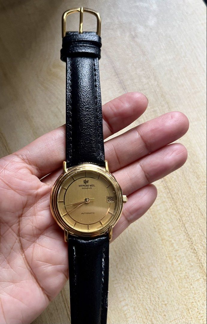 Raymond Weil Geneva Automatic Gold Watch (Category: Luxury Watches) located in Makati City. Submitted by lovefashionstuff (Listing ID 1468323716, Image 2). Description: Brand/Model: Raymond Weil Geneve Automatic Watch (Ref. 2811) Dial: Gold dial with convenient date window at the 3 o'clock position Case: 18k gold electroplated case with water-resistant caseback - Strap: Black genuine leather strap paired with a matching gold-tone buckle - Conditi