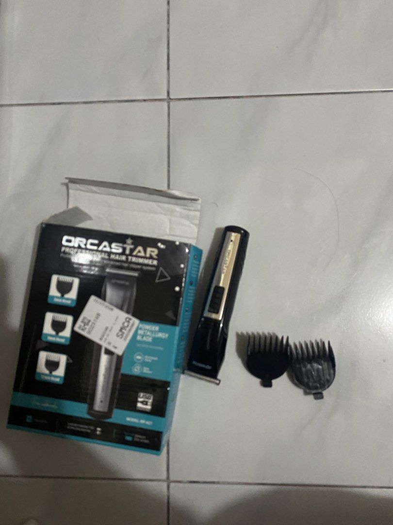 Razor (Category: Hair) located in Agdangan. Submitted by dos.xxx (Listing ID 1468323148, Image 1). Description: - Brand: Orcastar Professional - Color: Sleek black and silver design - Features: USB rechargeable for easy and convenient charging - Perfect for: Home haircuts, styling, and beard trimming - Inclusions: Original retail box and two black guide combs - Condition: Practical and reliable grooming tool.