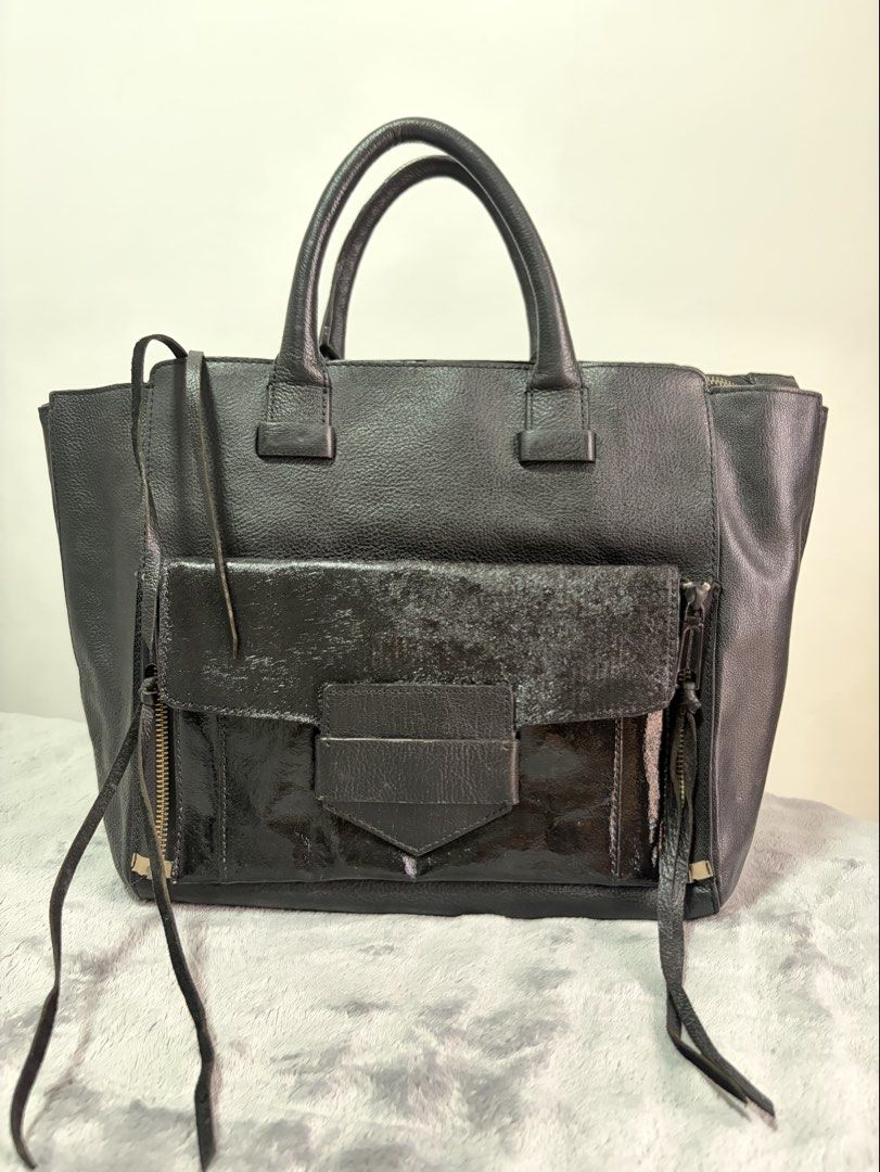 <Pre-loved> Rebecca Minkoff Black Large Structured Leather Tote Bag with Front Pocket (Category: Tote Bags) located in Malolos. Submitted by rainbow.06 (Listing ID 1468303687, Image 1). Description: - Material: Premium black structured leather with textured front pocket detail (repainted from b&w stripes to pure black) - Closure: Smooth main top zipper - Storage: Roomy interior with slip pockets and front exterior flap pocket - Details: Double to