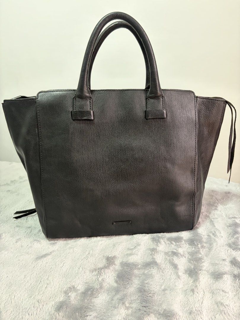 <Pre-loved> Rebecca Minkoff Black Large Structured Leather Tote Bag with Front Pocket (Category: Tote Bags) located in Malolos. Submitted by rainbow.06 (Listing ID 1468303687, Image 2). Description: - Material: Premium black structured leather with textured front pocket detail (repainted from b&w stripes to pure black) - Closure: Smooth main top zipper - Storage: Roomy interior with slip pockets and front exterior flap pocket - Details: Double to