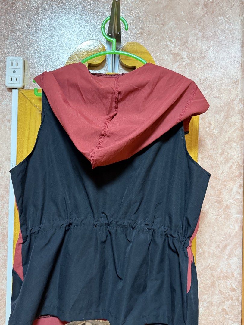 Red and Black Hooded Vest with Drawstrings (Category: Sleeveless) located in Bacoor. Submitted by happyfish_028a6c (Listing ID 1468444377, Image 2). Description: - Style: Sleeveless hooded vest - Color: Red with a contrasting black back panel and hood - Closure: Zip-up front with metal zipper pull - Fit: Adjustable drawstrings at the waist and hem - Pockets: Two front pockets included - Material: Lightweight and comfortable fabric.