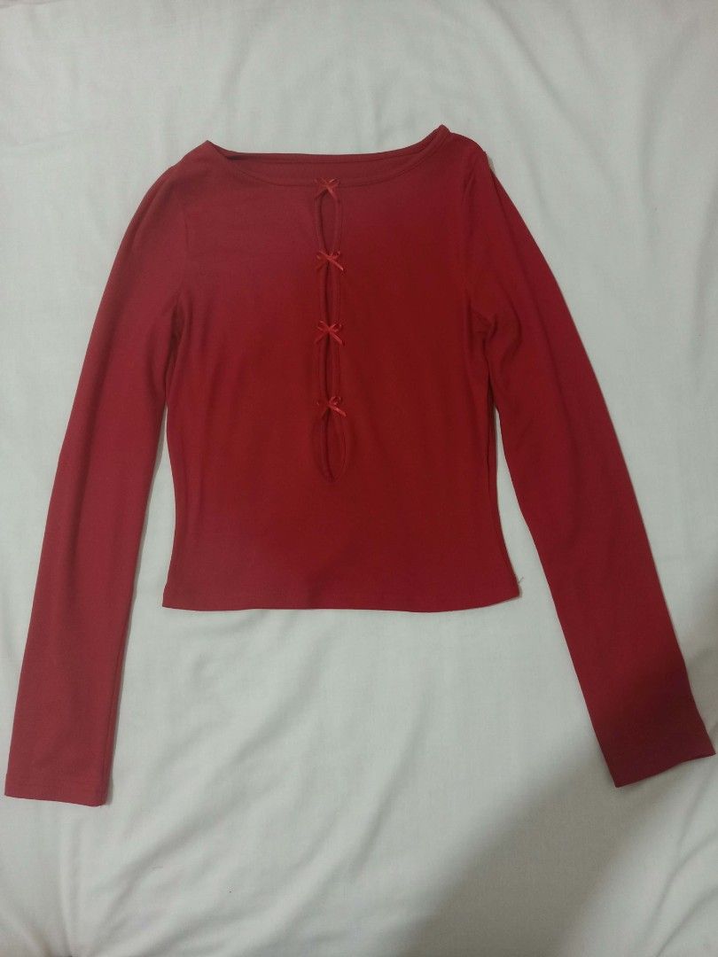 Red Bow Front Cutout Long Sleeve Top (Category: Longsleeves) located in Manila. Submitted by _sj1204 (Listing ID 1468409569, Image 3). Description: - Color: Red - Design: Round neckline with center cutout and 4 ribbon bow accents - Fit: Fitted silhouette made from soft, stretchy ribbed material - Styling: Versatile piece, perfect to pair with skirts or trousers for day or night - Condition: very like new (worn only once).