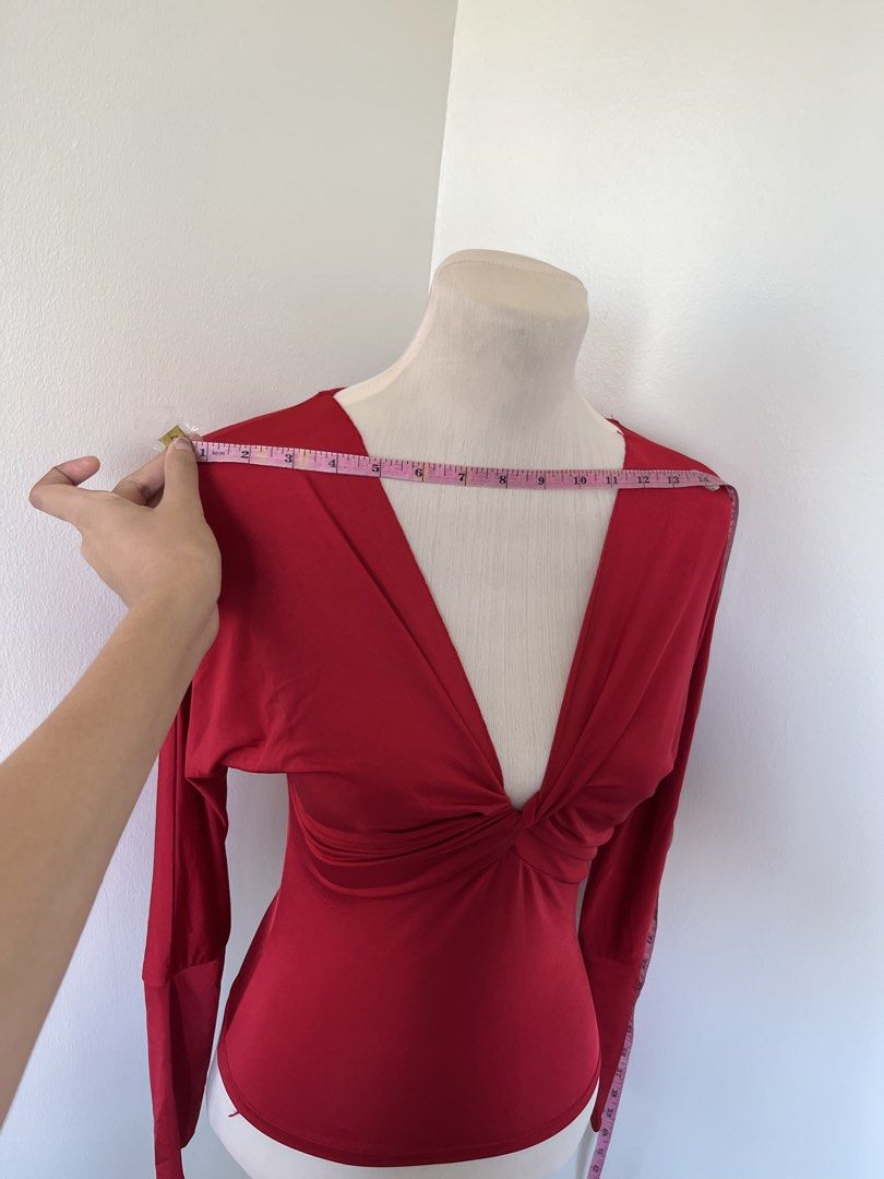 Red long sleeve deep V-neck top with front twist (Category: Longsleeves) located in Mandaluyong City. Submitted by bravedeer.020ad7 (Listing ID 1468368773, Image 3). Description: - Color: Bright red - Style: Long sleeves with a deep V-neck and front twist detail - Fit: Fitted silhouette, stretchy fabric - Dimensions: ~18 inches length (shoulder to hem), ~14 inches shoulder width - Occasion: Great for nights out or casual outings - Condition: Bran