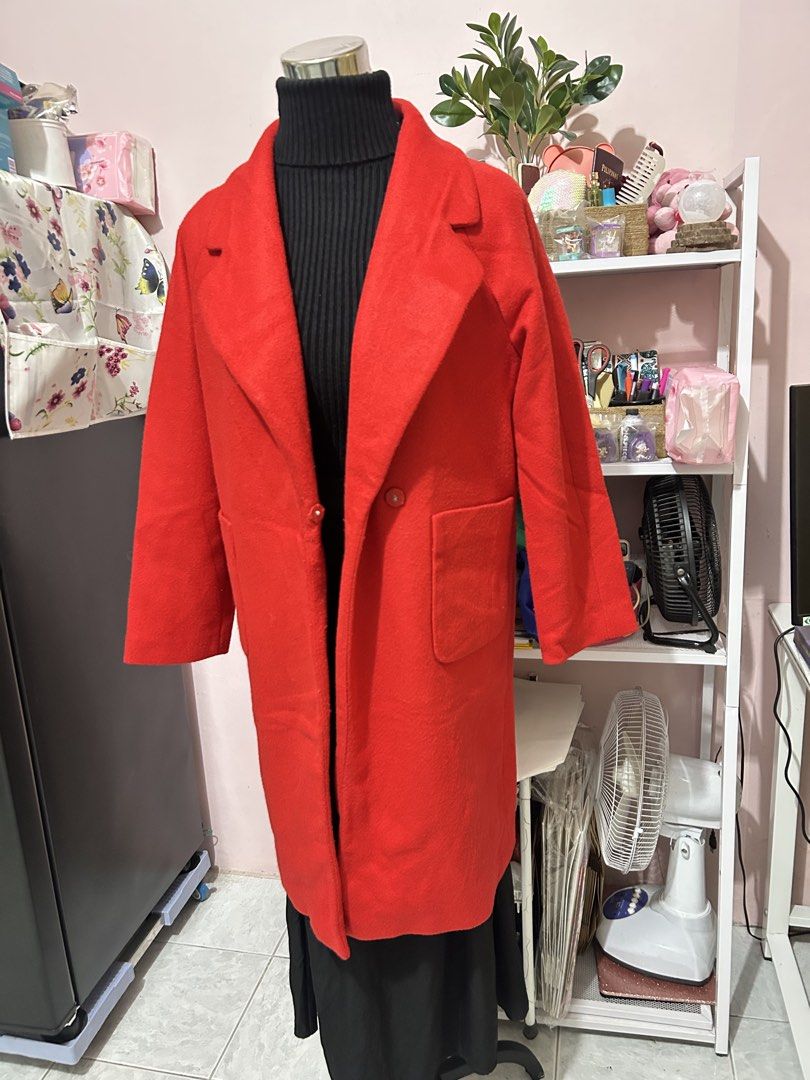 Red long wool coat trench jacket with pockets (Category: Coats, Jackets and Outerwear) located in Makati City. Submitted by aizy_sell (Listing ID 1468354326, Image 2). Description: - Color: Vibrant red - Style: Long, straight fit falling below the knees - Details: Wide lapel collar, single-button closure, and large side patch pockets - Fabric: Mid-weight, ideal for cooler weather - Finish: Tailored seams with a clean finish Size: Medium to Large.