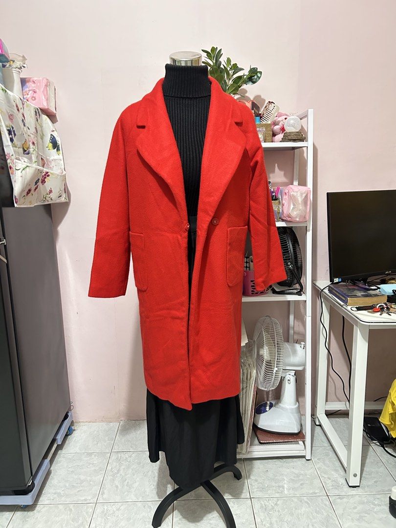 Red long wool coat trench jacket with pockets (Category: Coats, Jackets and Outerwear) located in Makati City. Submitted by aizy_sell (Listing ID 1468354326, Image 3). Description: - Color: Vibrant red - Style: Long, straight fit falling below the knees - Details: Wide lapel collar, single-button closure, and large side patch pockets - Fabric: Mid-weight, ideal for cooler weather - Finish: Tailored seams with a clean finish Size: Medium to Large.