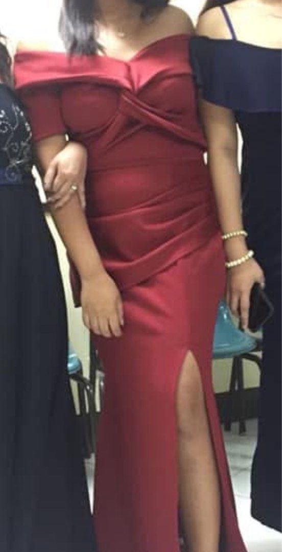 Red off-shoulder evening gown with slit (Category: Evening dresses & gowns) located in Manila. Submitted by geminibibo (Listing ID 1468443030, Image 2). Description: - Color: Maroon - Style: Off-shoulder neckline, wrapped front bodice, full-length skirt with a high leg slit - Condition: Worn once, freshly dry cleaned, ready to wear - Ideal for: Formal dinners, parties, and special events.