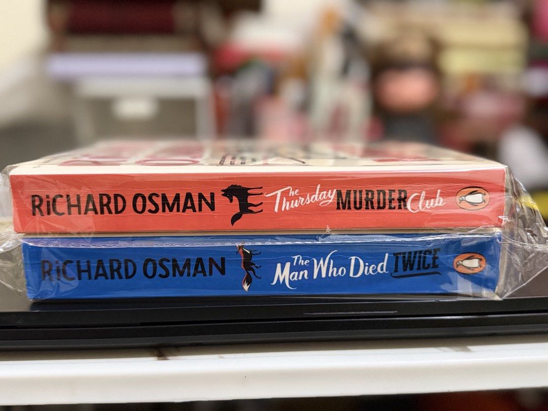 Richard Osman Bundle (Red and Blue) (Category: Storybooks) located in Silang. Submitted by papieriiibookstogo (Listing ID 1468303201, Image 1). Description: Preloved Cozy Mystery Bundle | Richard Osman Richard Osman: ₱270 bundle Genre: Cozy mystery, crime comedy • The Thursday Murder Club: Four retirees meet weekly to solve cold cases, until a real murder lands on their doorstep. • The Man Who Died Twice: The gang is back with a new puzzle involv