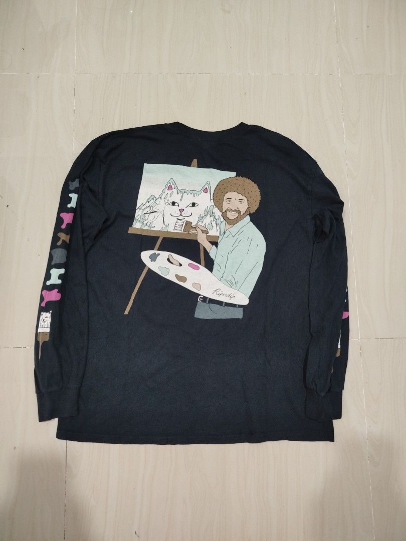 RIPNDIP Bob Ross Long Sleeve (Category: Tshirts & Polo Shirts ) located in Aroroy. Submitted by dr0p-a-dr1p (Listing ID 1468330560, Image 2). Description: Width: 21 Length: 27 10/10 color rate - Brand: Ripndip - Style: Black long sleeve crewneck shirt - Condition: Brand new with tags attached - Size: Large - Design details: Large Bob Ross cat landscape graphic on the back, small paintbrush on the chest, and colorful paint splatters on both sleeve