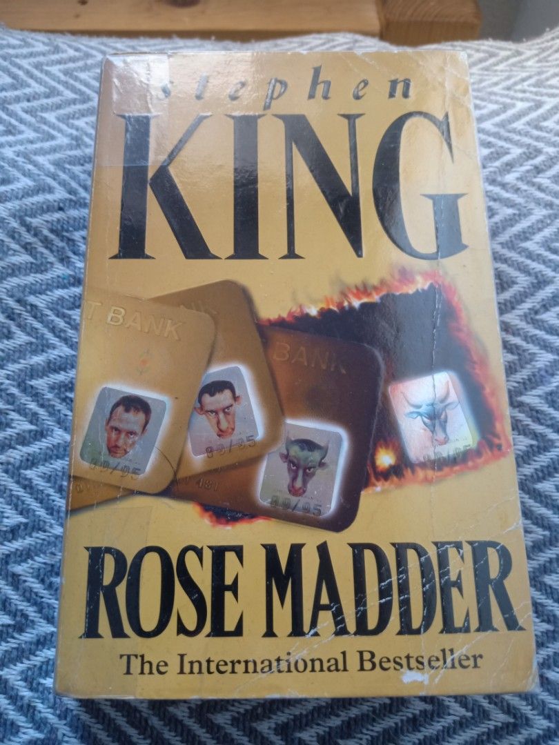 Rose Madder by Stephen King paperback novel (Category: Storybooks) located in Bacolor. Submitted by appletun (Listing ID 1468362021, Image 1). Description: all sales final. no returns/refunds/exchange. mop: gcash. no cod/cop/sco. handling/mod: spx +P70sf. - Title: Rose Madder by Stephen King - Format: Paperback edition - Cover: Distinctive yellow cover featuring credit cards and graphic art - Status: International bestseller - Condition: Readable