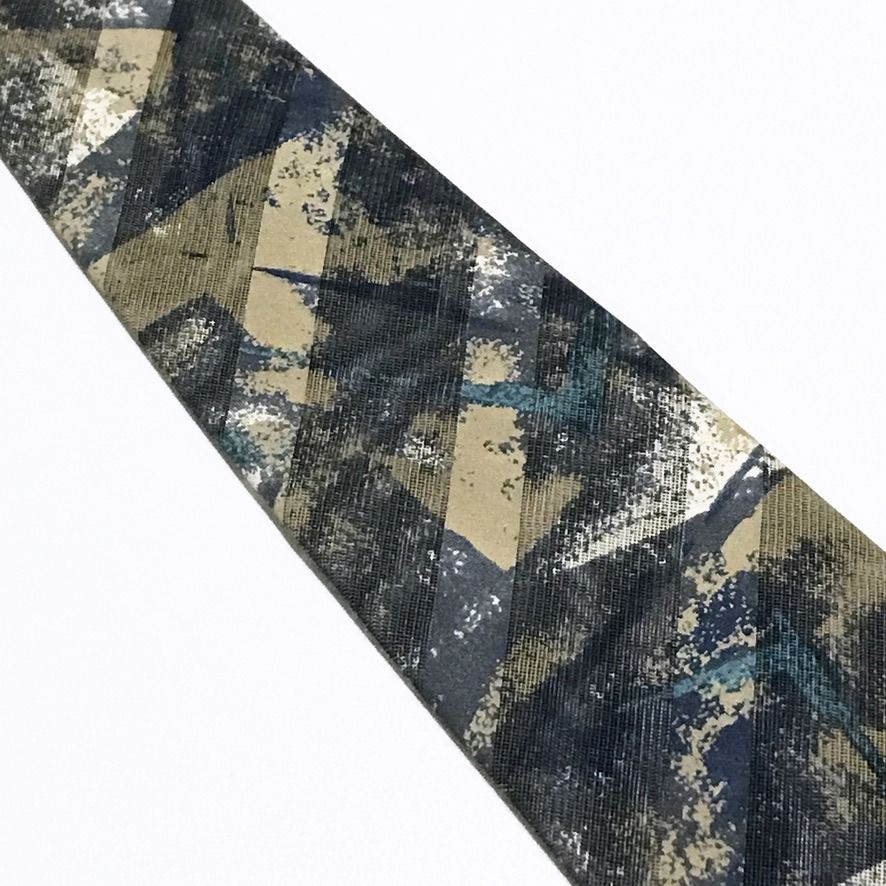Ruffeno NWT Abstract Pattern Textured Sheer Fabric Neck Tie (Category: Ties) located in Taguig. Submitted by retrogaze (Listing ID 1468313187, Image 3). Description: This 100% silk necktie by Ruffeno features a light-catching, sheer net-like mesh weave overlaid with a multi-textured abstract geometric pattern. The blade showcases dynamic, painterly diagonal brushstrokes and speckled textures in muted tones of slate blue, khaki tan, charcoal grey,