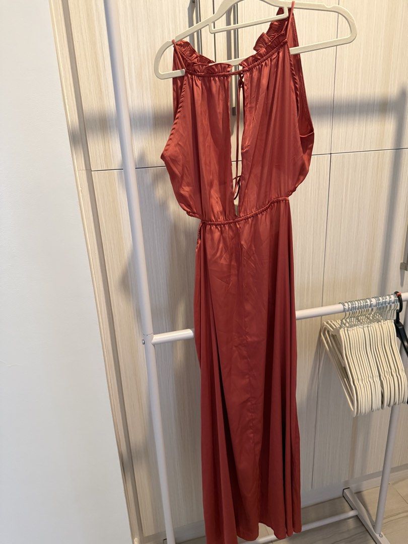 Rust Orange Halter Maxi Dress (Category: Dresses) located in Cebu City. Submitted by onlineclosetbypat (Listing ID 1468285030, Image 1). Description: - Color: Rust orange - Size: S - Material: Lightweight satin-like fabric - Design: Halter neck with ruffled collar trim - Details: Deep front split with tie accents at neckline and waist - Fit: Elasticated waistband for a comfortable fit - Condition: Brand new / Excellent.