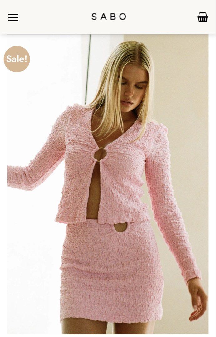 SABO Skirt Pink Textured Ring Two Piece Set Size M (Category: Sets or Coordinates) located in Quezon City. Submitted by mikaela_0 (Listing ID 1468354468, Image 3). Description: - Brand: SABO Skirt - Style: Pink two-piece set with long sleeve top and matching mini skirt - Material: Textured crinkle fabric - Details: Gold ring front closure on top, waist cutout with matching ring hardware on skirt - Size: both M (AU 10, US 6), fits small to medium 