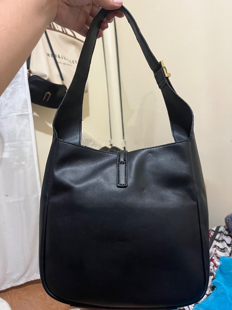 Saint Laurent Black Leather Hobo Bag (Category: Luxury Bags & Wallets) located in Rosario. Submitted by namayang_ (Listing ID 1468433074, Image 2). Description: - Brand: Saint Laurent (YSL) - Style: Hobo Bag - Material: Premium Black Leather - Hardware: Gold-tone with iconic YSL monogram - Strap: Adjustable shoulder strap with YSL stamped gold buckle - Interior: Includes zippered pocket and Saint Laurent leather brand tag - Origin: Made in Italy 