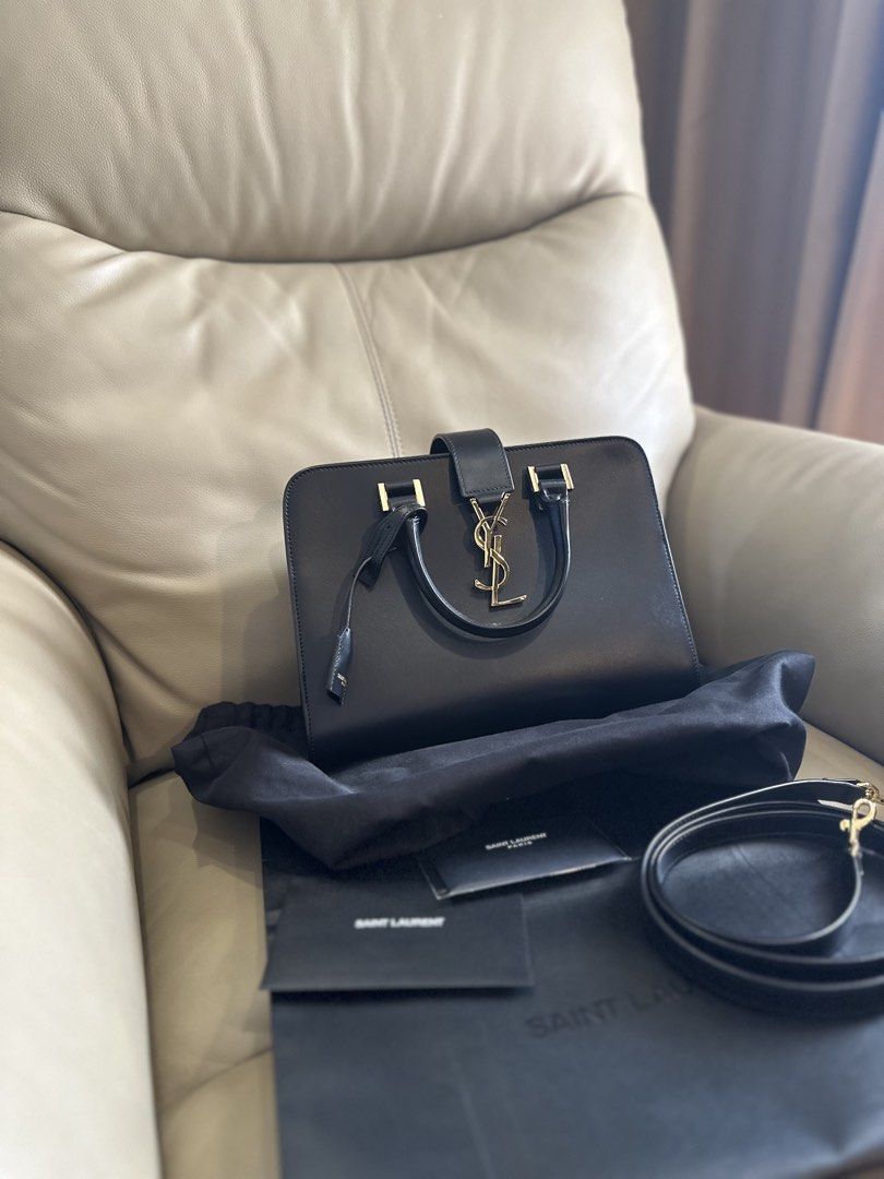 Saint Laurent YSL Cabas bag (Category: Luxury Bags & Wallets) located in Carmona. Submitted by jekslegaspi (Listing ID 1468290279, Image 1). Description: STORE BOUGHT - Brand: Saint Laurent (YSL) - Material: Premium black smooth calfskin leather - Hardware: Iconic gold-tone YSL interlocking logo with mirror shine - Structure: Structured rectangular shape with gold protective feet on the base - Straps: Dual top handles and a convenient detachable 
