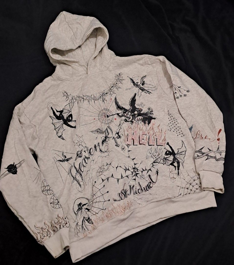 Saint Michael x Dr Woo Hoodie (Category: Hoodies) located in Puerto Princesa. Submitted by jercksthriftph (Listing ID 1468386713, Image 1). Description: Saint Michael x Dr Woo Hoodie , Size: XL 23 x 28 - Color: Heather grey - no tags / care tags - Design: All-over tattoo-style graphics with 'Heaven and Hell' and 'Battle For Your Soul' artwork - Details: Heavy prints on chest, back, and sleeves featuring angels, devils, and flames - Features: Comf