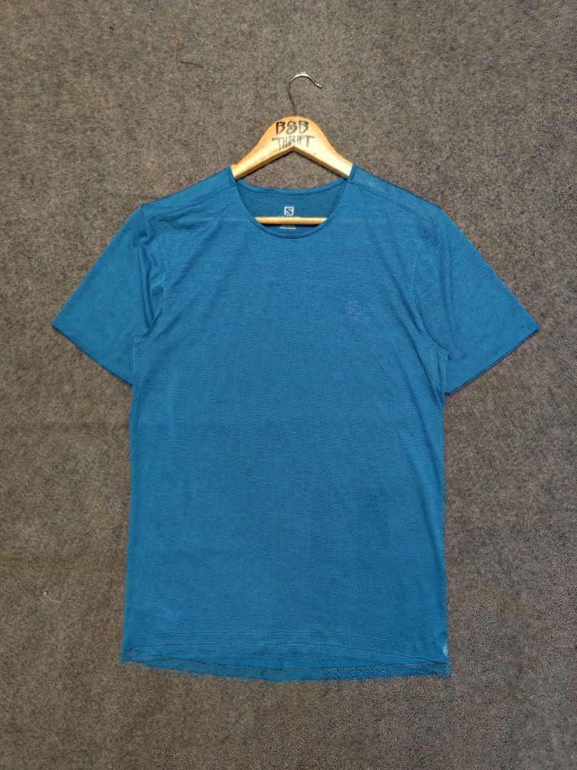 Salomon Blue Active Tech Tee (Category: Activewear) located in Cordova. Submitted by bsb.streetluxvintage.clothing (Listing ID 1468424693, Image 1). Description: - Brand: Salomon - Color: Bright blue with subtle heathered texture - Size: Medium - Material: 100% polyester with 37.5 tech for quick drying and moisture management - Features: Short sleeves, crew neck, and chest logo - Condition: Clean, inside and out - Ideal for: Running, hiking, and 