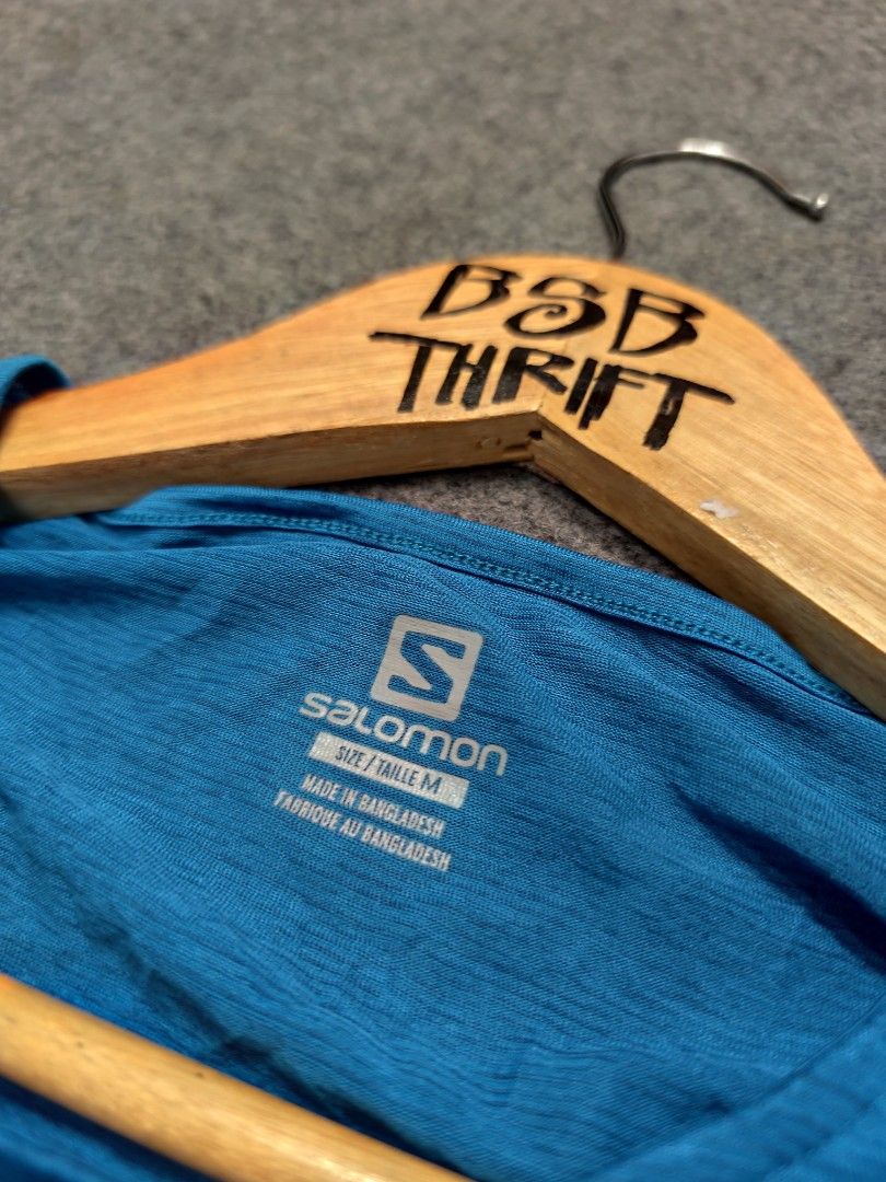 Salomon Blue Active Tech Tee (Category: Activewear) located in Cordova. Submitted by bsb.streetluxvintage.clothing (Listing ID 1468424693, Image 3). Description: - Brand: Salomon - Color: Bright blue with subtle heathered texture - Size: Medium - Material: 100% polyester with 37.5 tech for quick drying and moisture management - Features: Short sleeves, crew neck, and chest logo - Condition: Clean, inside and out - Ideal for: Running, hiking, and 