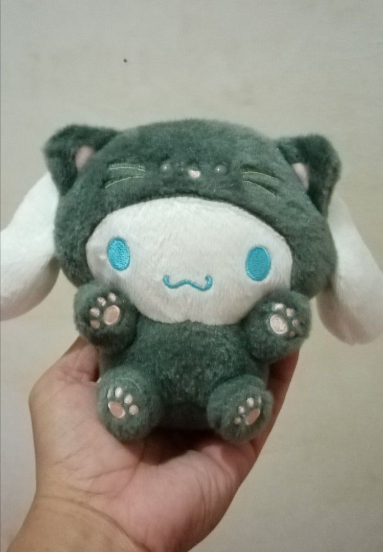 Sanrio Cinnamoroll Cat Onesie Plush (Category: Plushies & Soft Toys) located in Bulacan. Submitted by renasophiatoystore2020 (Listing ID 1468496132, Image 1). Description: - Authentic Sanrio Cinnamoroll plush doll - Adorable dark green cat costume design - Features white floppy ears, embroidered blue eyes, and pink paw pads - Comes with official tag attached - Clean fabric, carefully maintained by adult owner - Smoke-free and pet-free home.