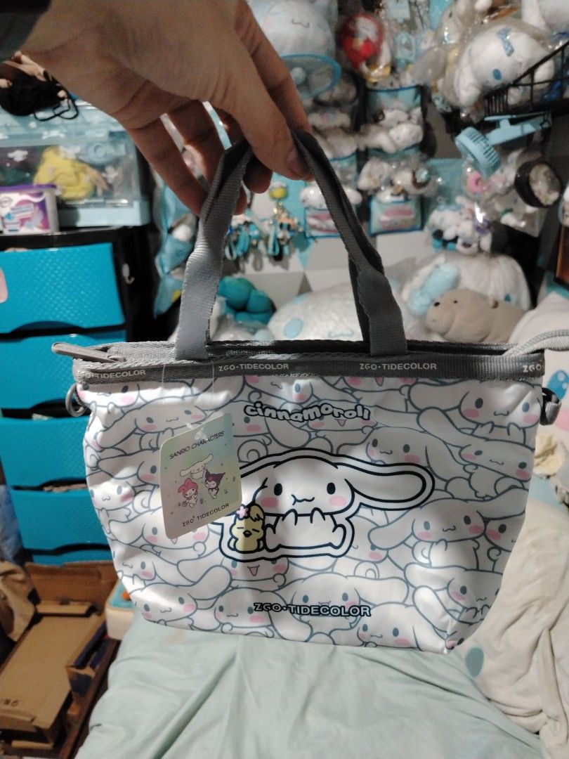 Sanrio Cinnamoroll Tote Bag ZGO TIDECOLOR (Category: Tote Bags) located in Manila. Submitted by joycechua439850 (Listing ID 1468302749, Image 2). Description: - 100% Authentic Sanrio Cinnamoroll merchandise - Cute all-over print on a white base with stylish grey straps - Features a handy front pocket with a larger Cinnamoroll patch - Secure top zipper closure to keep your belongings safe - Convenient interior zip pocket for small essentials - Bra