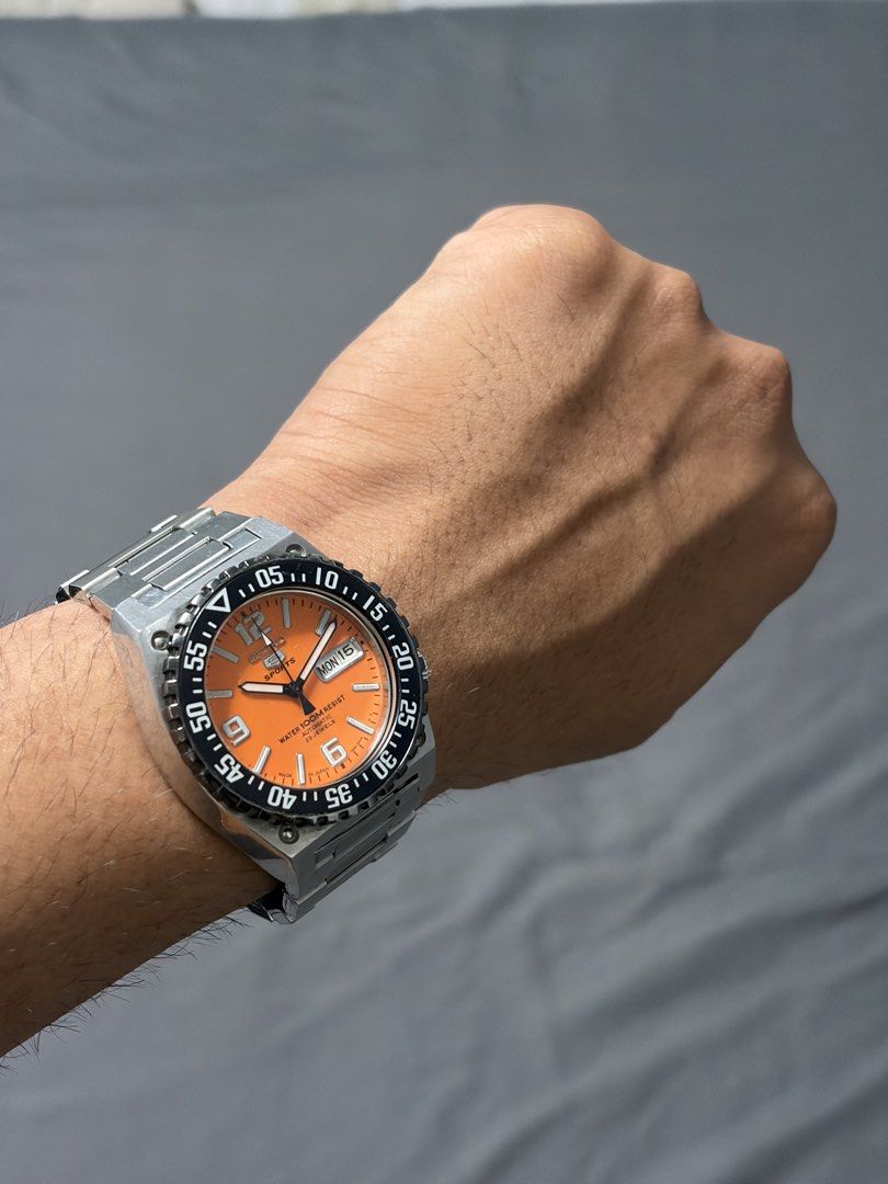Seiko 5 Sports Automatic Orange Dial (Category: Men's Watches) located in Manila. Submitted by jdn_phlp (Listing ID 1468476610, Image 3). Description: - Brand/Model: Seiko Automatic Watch (mod) original parts no box/ papers since it’s a custom build Build: 7s26 movement 4:00posStainless steel case and bracelet with signed Seiko clasp, plus a black rotating bezel Can polish for an extra 300 21 jewels - Water Resistance: Up to 100m - Condition: Nor