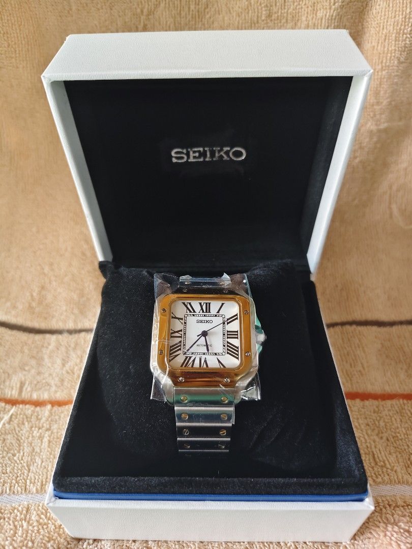 Seiko Automatic Square Watch Two-Tone MOD (Category: Women's Watches) located in Manila. Submitted by rarewind.cb1244 (Listing ID 1468315949, Image 1). Description: - Brand: Seiko - Movement: Automatic mechanical with exhibition case back - Dial: White with classic Roman numerals and railway minute track - Bracelet: Two-tone steel and gold with visible screw accents - Condition: Brand new with protective plastic wrapping still attached - Inclusio