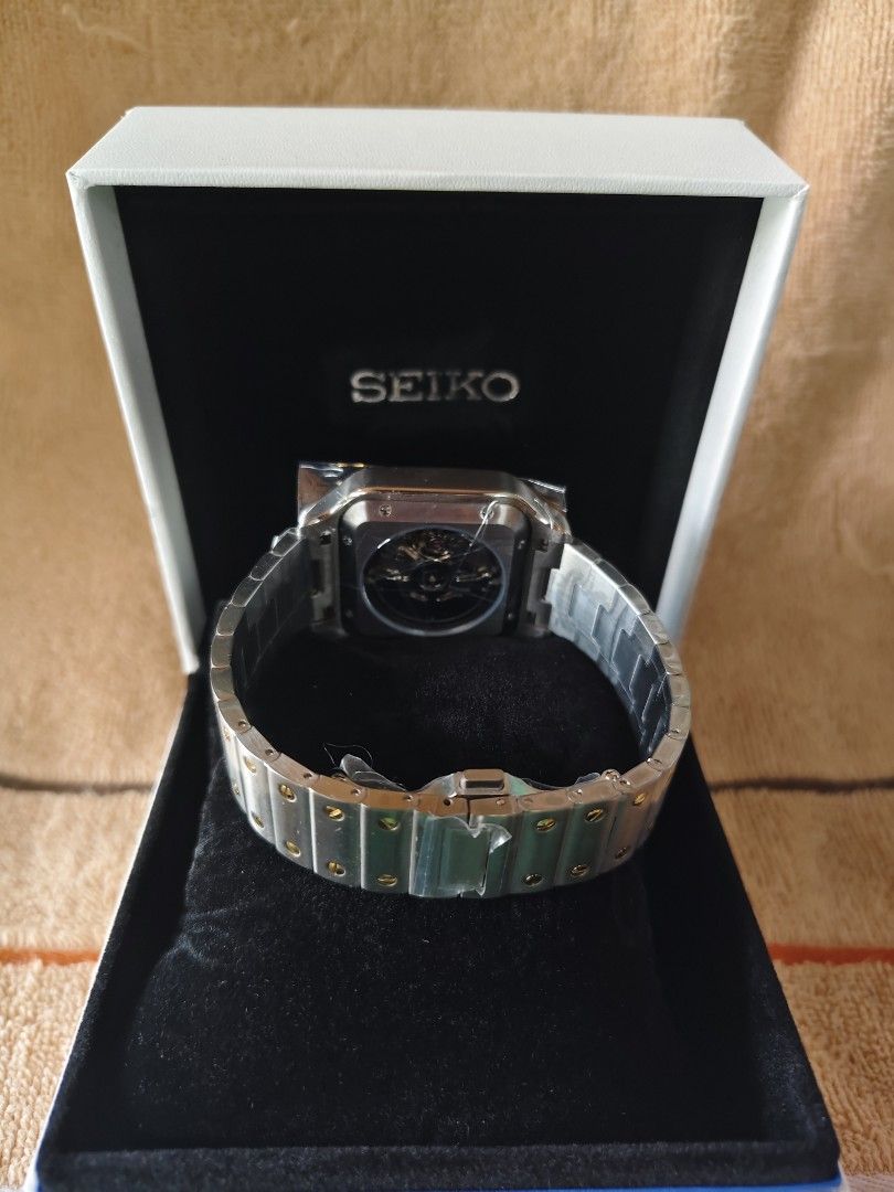 Seiko Automatic Square Watch Two-Tone MOD (Category: Women's Watches) located in Manila. Submitted by rarewind.cb1244 (Listing ID 1468315949, Image 2). Description: - Brand: Seiko - Movement: Automatic mechanical with exhibition case back - Dial: White with classic Roman numerals and railway minute track - Bracelet: Two-tone steel and gold with visible screw accents - Condition: Brand new with protective plastic wrapping still attached - Inclusio