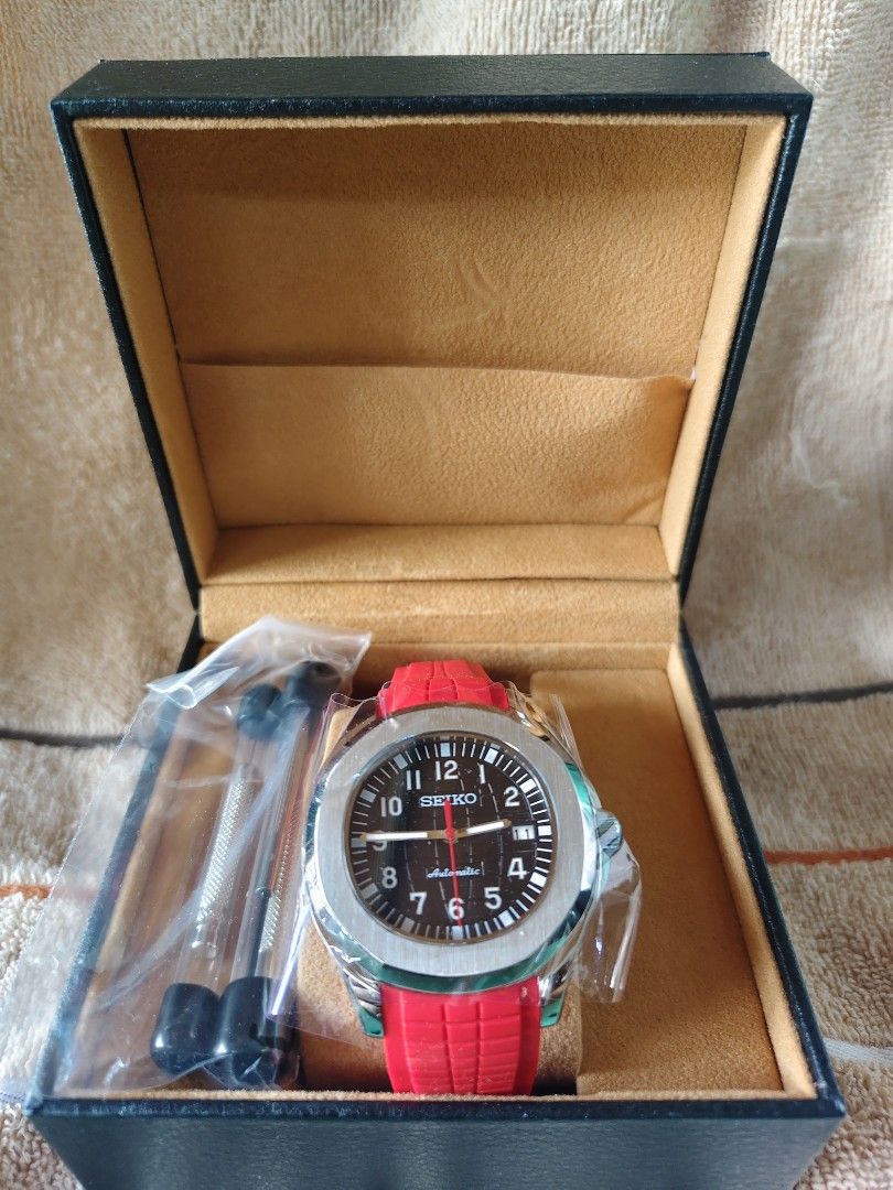 Seiko Automatic Watch with Red Strap and Presentation Box MOD (Category: Men's Watches) located in Manila. Submitted by rarewind.cb1244 (Listing ID 1468315484, Image 1). Description: - Brand: Seiko Automatic Watch - Dial: Black dial with clear white Arabic numerals and date window at 3 o'clock - Strap: Eye-catching bright red rubber strap equipped with a secure deployment clasp - Case Back: Transparent exhibition glass revealing the automatic mec