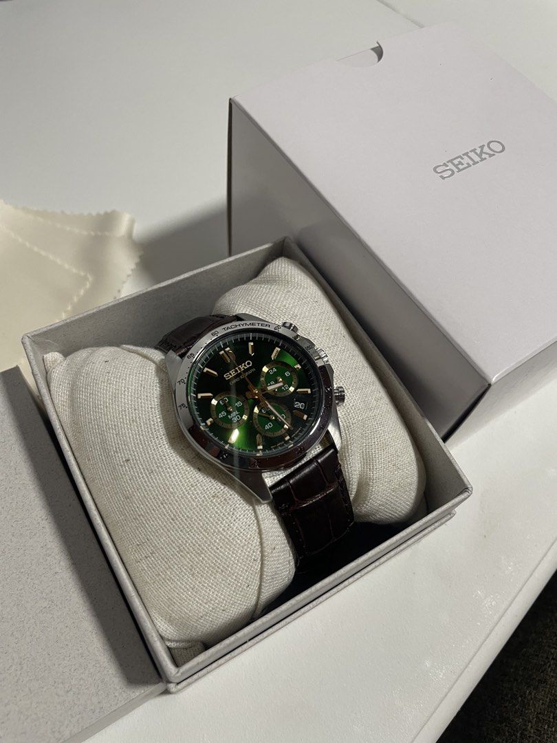Seiko Chronograph SBTR017 “Money Green” (Category: Men's Watches) located in Manila. Submitted by kennethv (Listing ID 1468401377, Image 2). Description: - Model: Seiko Chronograph Watch - Dial: Deep green with elegant gold indices and hands - Case: Silver-tone stainless steel with a practical date window at the 4 o'clock position - Functions: Fully functional chronograph sub-dials - Strap: Dark brown leather with stylish crocodile embossing - In