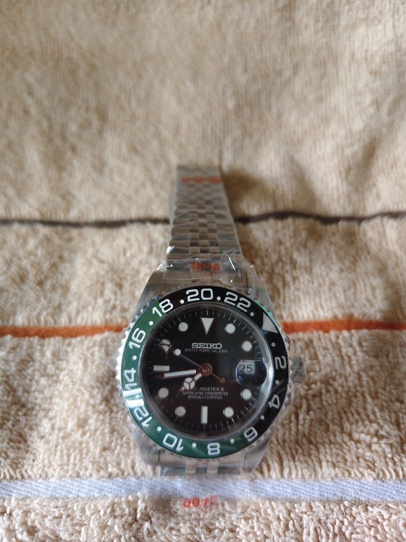 Seiko GMT Master II Sprite Mod Watch (Category: Men's Watches) located in Manila. Submitted by rarewind.cb1244 (Listing ID 1468316600, Image 1). Description: - Model: Seiko GMT 'Sprite' Mod - Bezel: Iconic black and green - Dial: Black with luminous markers and hands - Movement: Automatic with 3 o'clock date window - Bracelet: Jubilee-style stainless steel (brand new, plastic still wrapped) - Condition: Unworn, straight from storage.