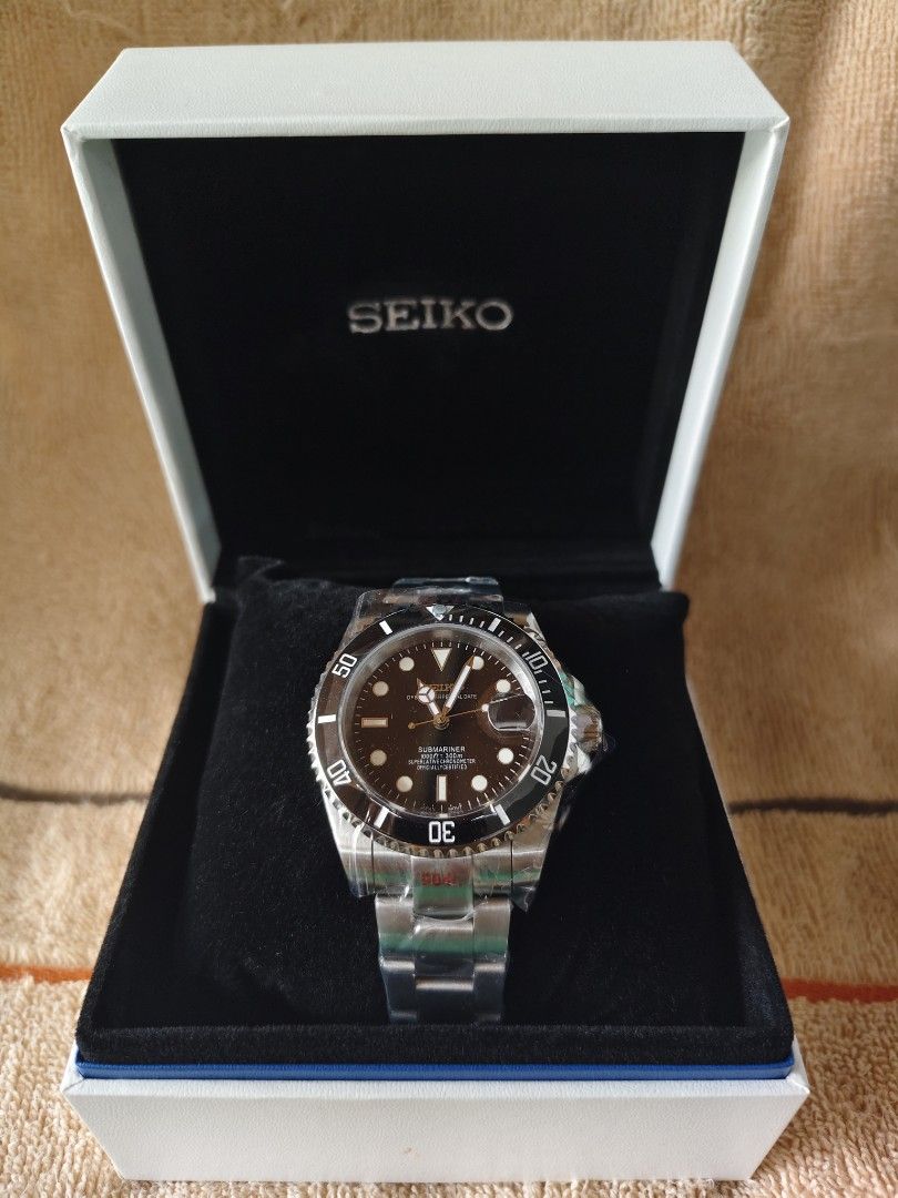 Seiko Submariner Automatic Watch with Box MOD (Category: Men's Watches) located in Manila. Submitted by rarewind.cb1244 (Listing ID 1468315873, Image 1). Description: - Brand: Seiko Submariner - Movement: Automatic mechanical movement with exhibition case back - Dial & Bezel: Black dial with round hour markers and rotating bezel - Band: Stainless steel bracelet (wrapped in protective original plastic) - Inclusions: Branded white presentation box 