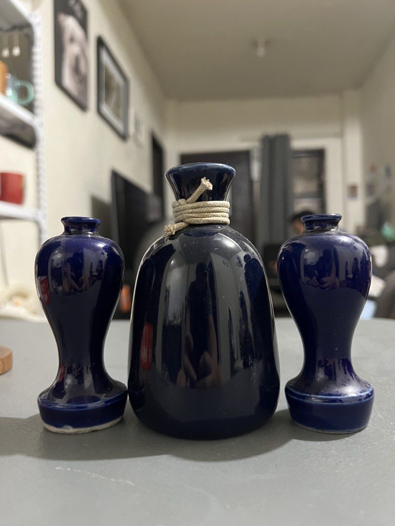 Set of Three Deep Blue Ceramic Vases (Category: Vases & Decorative Bowls) located in Manila. Submitted by ajdfinds (Listing ID 1468382673, Image 1). Description: - Set of 3 matching ceramic vases in a sleek, glossy dark blue finish - Includes 1 central bottle-shaped vase with charming rope-wrapped neck detail - Includes 2 smaller, elegant hourglass-shaped side vases - Smooth glazed surface beautifully catches and reflects the light - Ideal minima