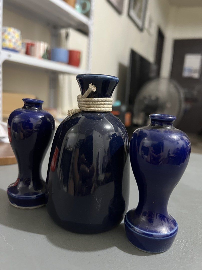 Set of Three Deep Blue Ceramic Vases (Category: Vases & Decorative Bowls) located in Manila. Submitted by ajdfinds (Listing ID 1468382673, Image 2). Description: - Set of 3 matching ceramic vases in a sleek, glossy dark blue finish - Includes 1 central bottle-shaped vase with charming rope-wrapped neck detail - Includes 2 smaller, elegant hourglass-shaped side vases - Smooth glazed surface beautifully catches and reflects the light - Ideal minima