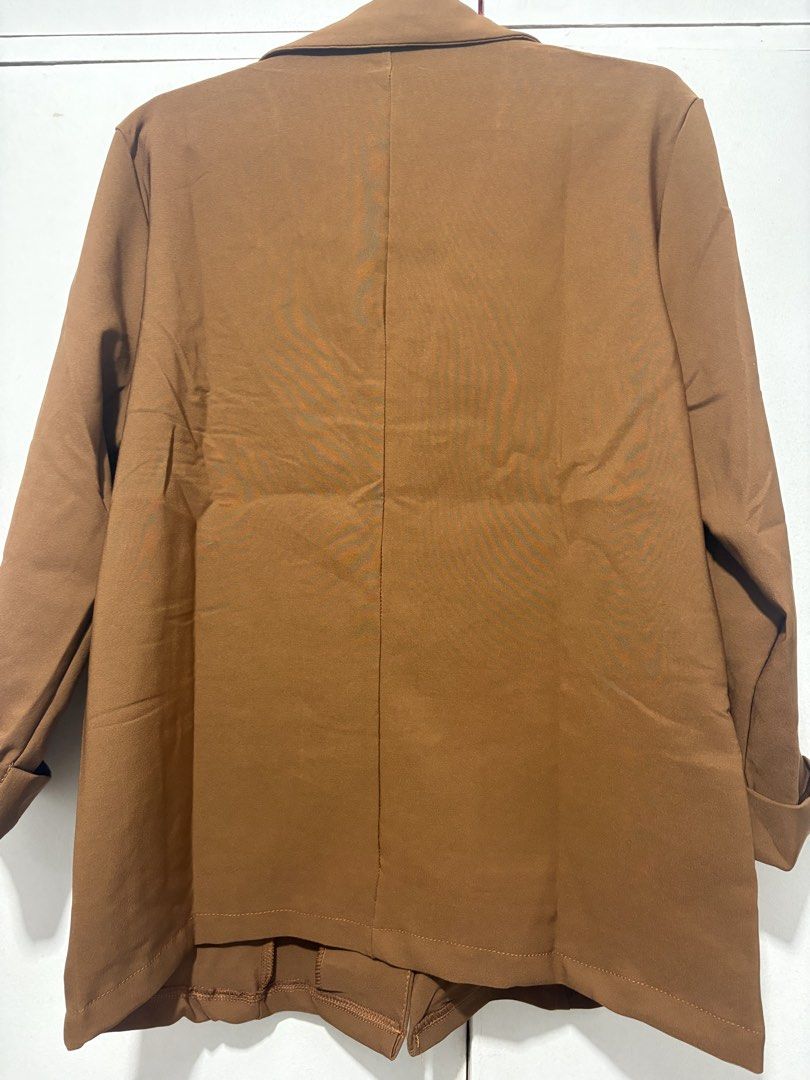 S.G. Brown Blazer Jacket Size XL #58119 (Category: Coats, Jackets and Outerwear) located in Manila. Submitted by pinchees_place (Listing ID 1468411014, Image 3). Description: - Brand: S.G. Fashion - Size: XL (Brand New with Tags) - Color: Solid Brown - Closure: Single front button - Design: Standard lapel collar, rolled sleeves, and faux side pockets - Details: Clean back with center seam detail - Condition: Brand new, never worn.
