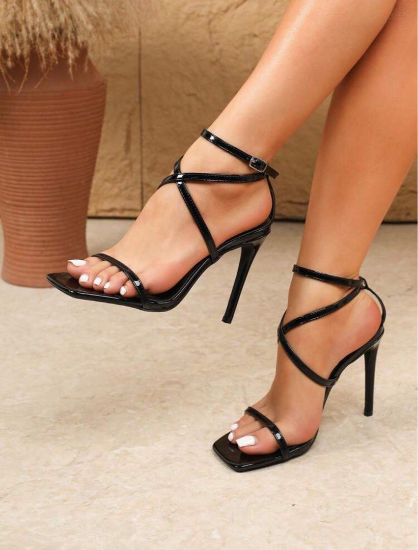 Shein Black Strappy High Heel Sandals (Category: Heels) located in Manila. Submitted by goddesssy (Listing ID 1468300793, Image 1). Description: - Color: Glossy Black - Style: High heel stiletto sandals with open square toe - Details: Thin criss-cross ankle straps with metal buckle closure - Condition: Brand new, tried on indoors once only.