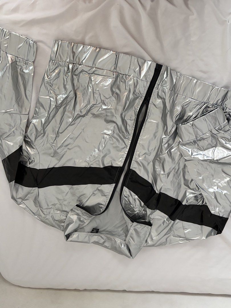 SHEIN Curve Silver Metallic Zip Jacket Size 1XL (Category: Coats, Jackets and Outerwear) located in Las Pinas. Submitted by thriftedfinds_ (Listing ID 1468394861, Image 2). Description: - Size: 1XL - Color: Silver metallic with bold black stripe - Closure: Full front black zipper - Features: Stand collar, elasticized cuffs, elasticized hem, lightweight shiny finish - Origin: Made in China.