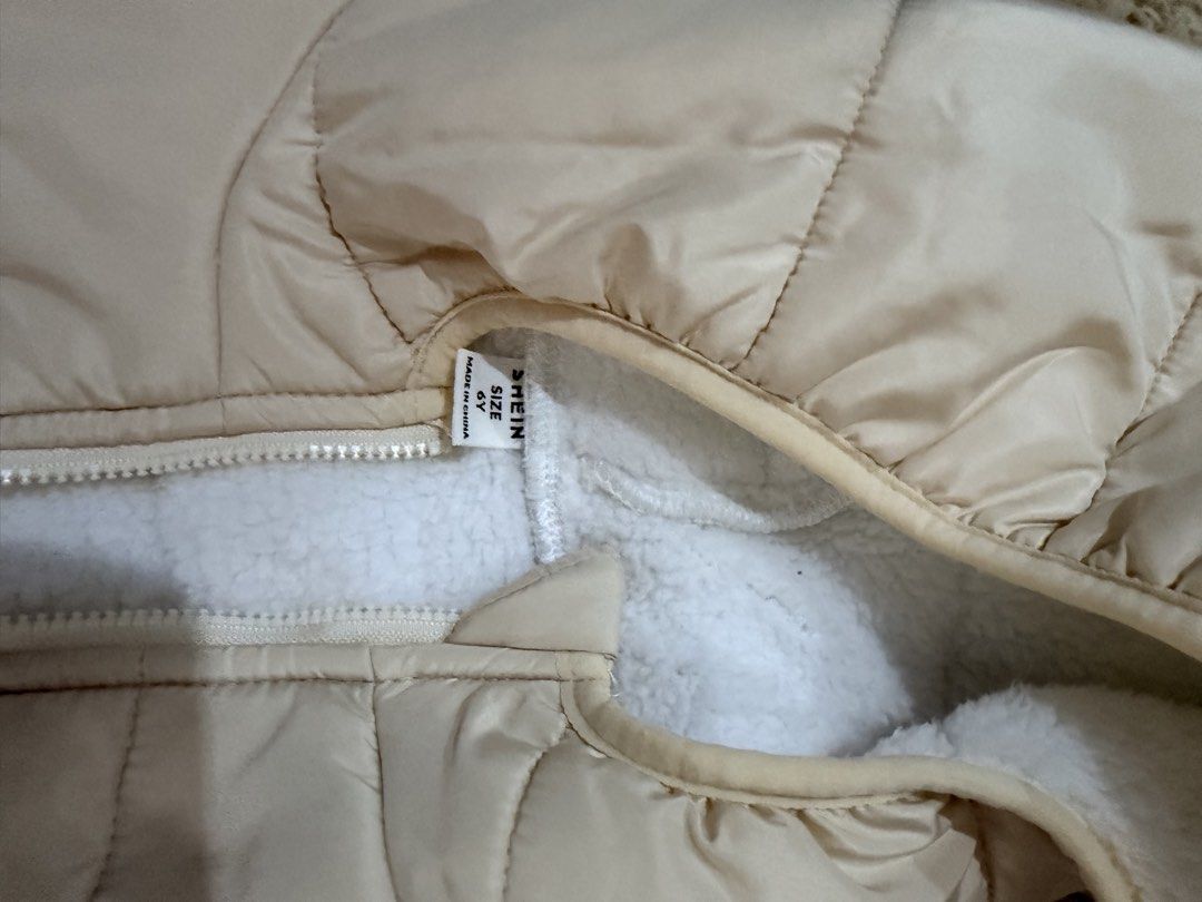 Shein Puffer Jacket 6Y (Category: Coats, Jackets and Outerwear) located in Quezon City. Submitted by adagavin (Listing ID 1468326977, Image 2). Description: - Brand: Shein - Size: 6Y - Color: Cream - Condition: Worn only once, practically spotless - Details: Cozy soft white fuzzy lining inside and on the hood, full zip front closure.