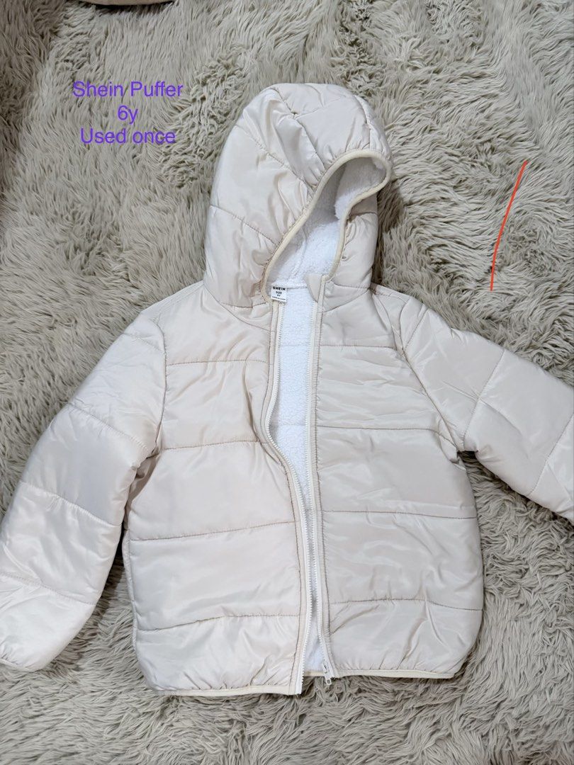 Shein Puffer Jacket 6Y (Category: Coats, Jackets and Outerwear) located in Quezon City. Submitted by adagavin (Listing ID 1468326977, Image 1). Description: - Brand: Shein - Size: 6Y - Color: Cream - Condition: Worn only once, practically spotless - Details: Cozy soft white fuzzy lining inside and on the hood, full zip front closure.
