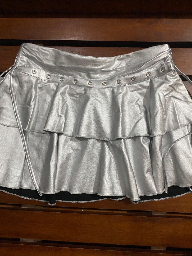 SHEIN Silver Metallic Ruffle Skirt Size M (Category: Skirts) located in Pateros City. Submitted by strawberhyun (Listing ID 1468374066, Image 1). Description: - Brand: SHEIN - Size: Medium (M) - Color/Finish: Silver metallic with a shiny finish - Design: Layered ruffle skirt with eyelet waistband and side tie strings - Lining: Comfortable black lining underneath - Material: 93% polyester, 7% elastane - Perfect for: Parties, night outs, and statem