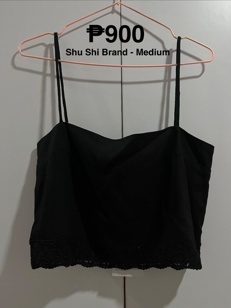 Shu Shi Black Tank Top Medium (Category: Sleeveless) located in Caloocan City. Submitted by safemountain.0b3a05 (Listing ID 1468395701, Image 1). Description: - Brand: Shu Shi - Size: Medium (standard fit) - Color: Solid black - Design: Straight neckline with delicate lace trim along the bottom hem - Material: Lightweight and comfortable fabric - Versatility: Easy to mix and match with shorts, skirts, or jeans; great for warm weather or layering.