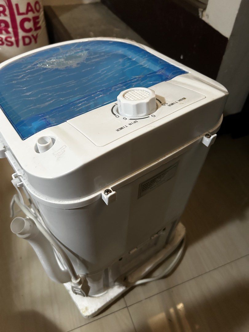 Single Drum Mini Washing Machine 300W (Category: Washing Machines and Dryers) located in Bulacan. Submitted by jseongcart_ (Listing ID 1468362415, Image 2). Description: - Type: Compact single drum portable washing machine - Power: 180-220V, 300W, 60Hz - Features: Blue lid, internal basket, and top control timer knob - Includes: Drain hose and power cord - Ideal for: Small laundry loads and tight spaces like dorms or condos rfs: decluttering.