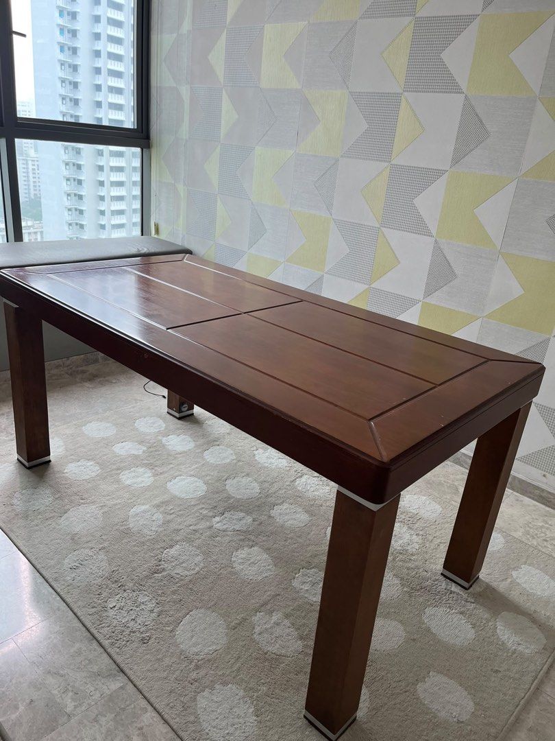 Solid Wooden Dining Table with Rectangular Top (Category: Tables & Sets) located in Singapore. Submitted by secondflex (Listing ID 1468308119, Image 2). Description: - Material: Sturdy solid wood construction - Color/Finish: Rich dark brown with decorative surface panel details - Design: Thick square legs featuring stylish silver metallic trim accents at top and bottom - Capacity: Standard seating capacity, fits dining rooms or spacious kitchens 