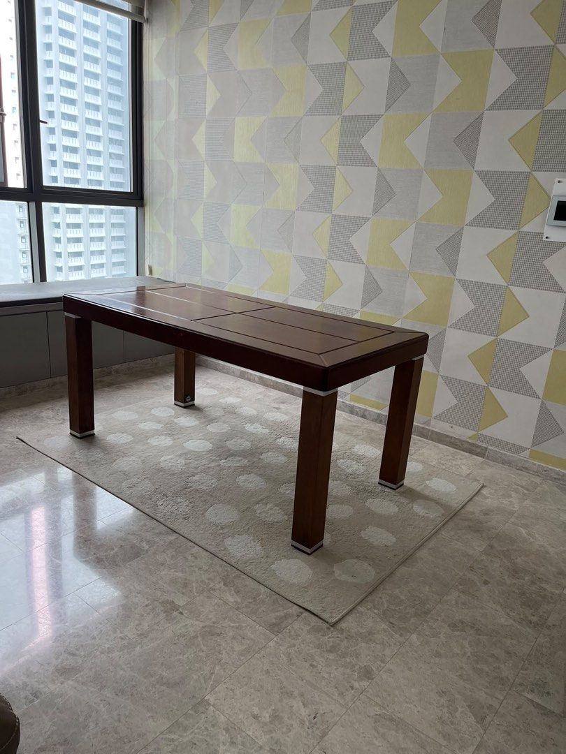 Solid Wooden Dining Table with Rectangular Top (Category: Tables & Sets) located in Singapore. Submitted by secondflex (Listing ID 1468308119, Image 3). Description: - Material: Sturdy solid wood construction - Color/Finish: Rich dark brown with decorative surface panel details - Design: Thick square legs featuring stylish silver metallic trim accents at top and bottom - Capacity: Standard seating capacity, fits dining rooms or spacious kitchens 