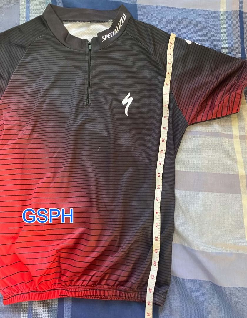 Specialized Black and Red Gradient Cycling Jersey (Category: Activewear) located in Makati City. Submitted by goodiesstuff_ph_17119811 (Listing ID 1468434445, Image 3). Description: - Brand: Specialized - Design: Black to red gradient with subtle horizontal stripes - Features: Short sleeves, front half zipper, and rear 3 pockets with branding - Material: Lightweight and breathable cycling fabric - Size/Measurements (laid flat): Length ~24", Chest