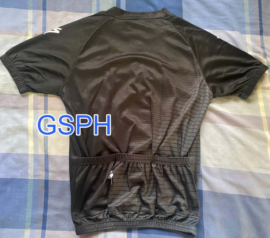 Specialized Black Cycling Jersey Short Sleeve Size S (Category: Activewear) located in Makati City. Submitted by goodiesstuff_ph_17119811 (Listing ID 1468435677, Image 2). Description: - Color: Sleek black with white branding on the collar and chest - Design: Short sleeve, half zip front closure, and textured striped pattern - Storage: Traditional 3-pocket setup on the lower back - Fit: Elastic hem to keep the jersey secure while riding - Measure