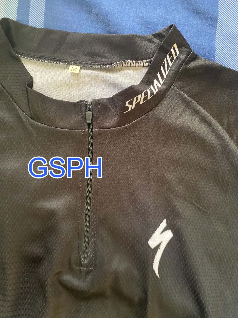 Specialized Black Cycling Jersey Short Sleeve Size S (Category: Activewear) located in Makati City. Submitted by goodiesstuff_ph_17119811 (Listing ID 1468435677, Image 3). Description: - Color: Sleek black with white branding on the collar and chest - Design: Short sleeve, half zip front closure, and textured striped pattern - Storage: Traditional 3-pocket setup on the lower back - Fit: Elastic hem to keep the jersey secure while riding - Measure