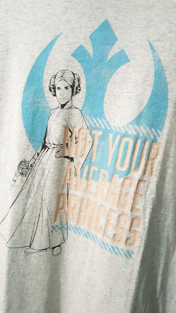 Star Wars Princess Leia (Not Your Average Princess) (Category: Shirts) located in Taguig. Submitted by wethrifting2021 (Listing ID 1468417982, Image 2). Description: Item: Princess Leia🔥 Size: OPT Starwars (L) Width: 22 Length: 28.5 Condition: Excellent Issue: Hairline, Pinhole on hem SWIPE MORE DETAILS. DM to purchase 📩.