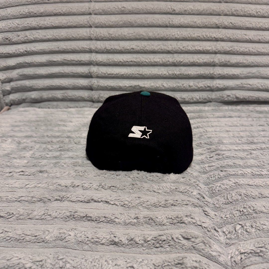 Starter Miami Dolphins Vintage Snapback Cap (Category: Caps & Hats) located in Agdangan. Submitted by kiiiiingg (Listing ID 1468436246, Image 2). Description: - Authentic vintage Starter snapback hat - Miami Dolphins embroidered logo on the front - Classic black crown, teal brim, and green undervisor - Officially licensed NFL product made of 100% wool - Adjustable plastic snap closure with iconic Starter star embroidery.