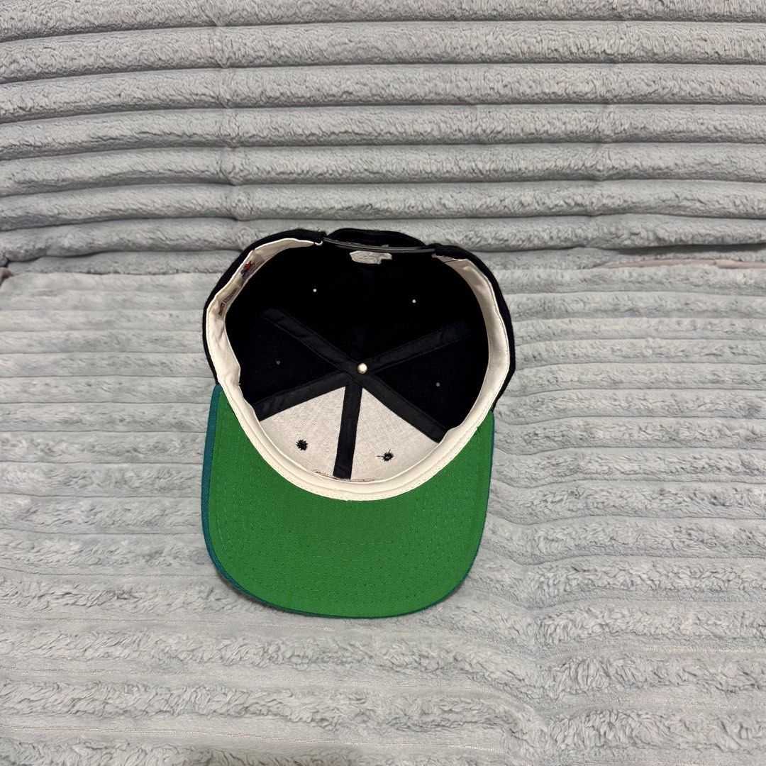 Starter Miami Dolphins Vintage Snapback Cap (Category: Caps & Hats) located in Agdangan. Submitted by kiiiiingg (Listing ID 1468436246, Image 3). Description: - Authentic vintage Starter snapback hat - Miami Dolphins embroidered logo on the front - Classic black crown, teal brim, and green undervisor - Officially licensed NFL product made of 100% wool - Adjustable plastic snap closure with iconic Starter star embroidery.